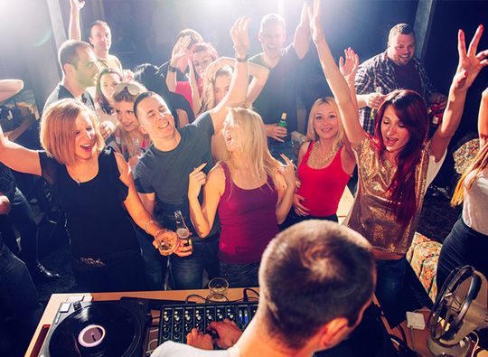 An image of young people enjoying themselves at a night club.