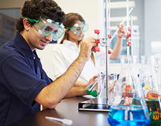 An image of a person wearing safety goggles in a laboratory setting.